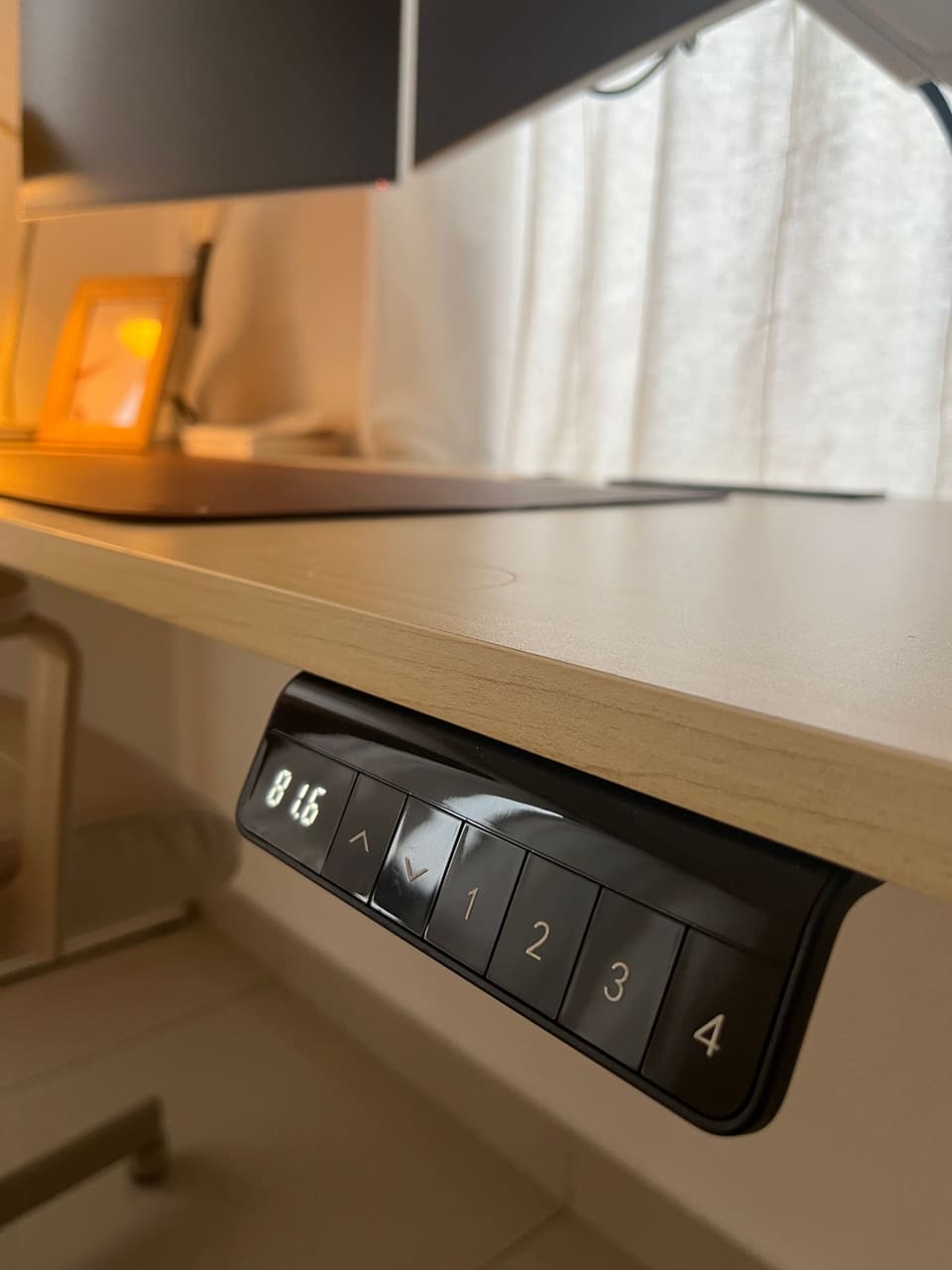 Close-up of the electric desk height controls with memory presets